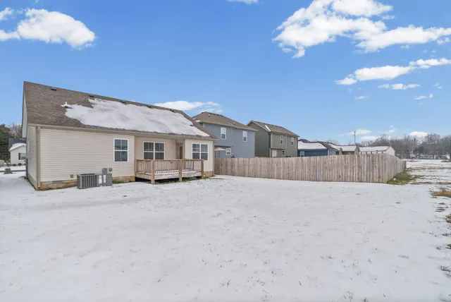 a view of a house with a snow in the background