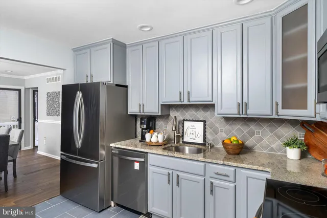 a kitchen with stainless steel appliances granite countertop a refrigerator sink and cabinets