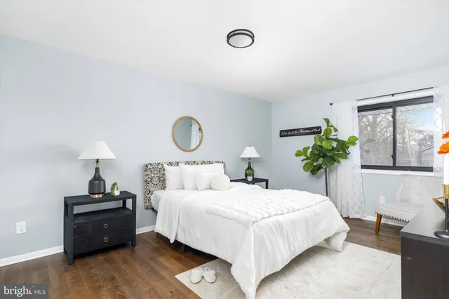 a bedroom with a bed and a potted plant