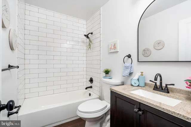 a bathroom with a sink a toilet and a bathtub