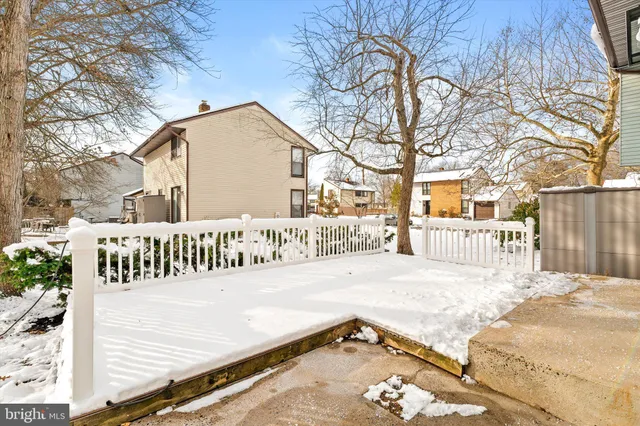 a view of a street with a bench in front of house