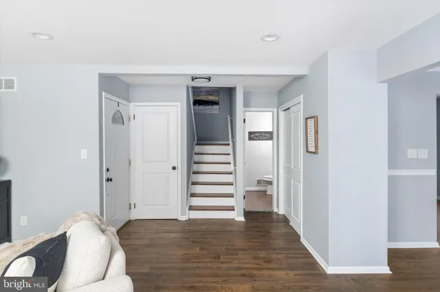 a view of a hallway with wooden floor and entryway
