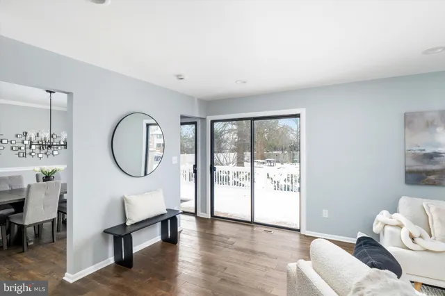 a living room with furniture a window and a chandelier