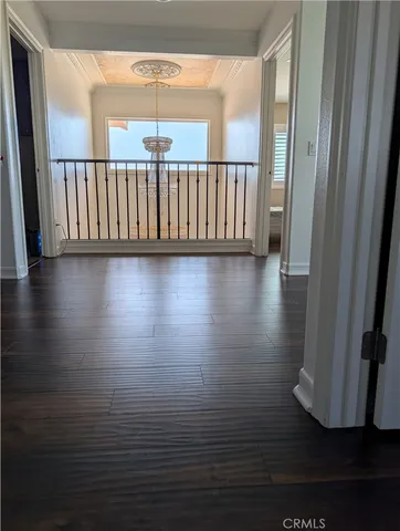 a view of a room with wooden floor
