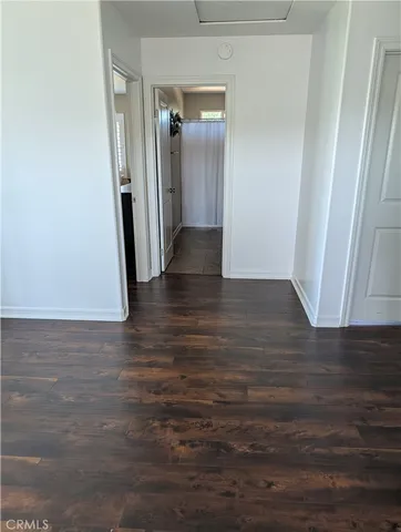 a view of a hallway with wooden floor