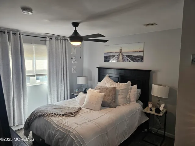 a bedroom with bed and a night stand