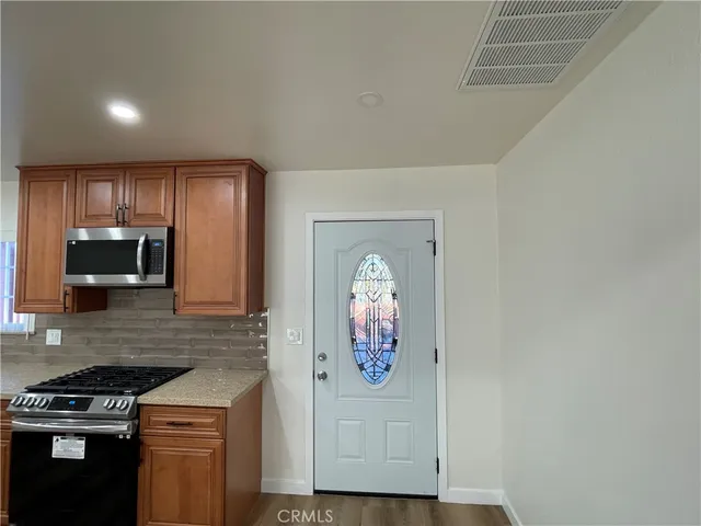 a kitchen with granite countertop cabinets and steel stainless steel appliances
