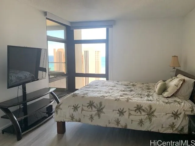 a bedroom with a bed and glass window