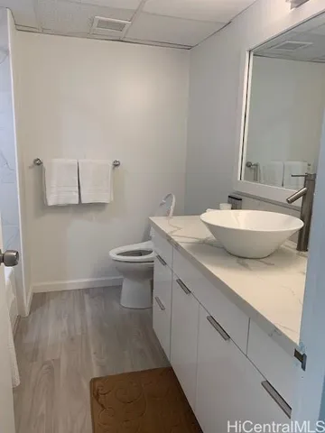 a bathroom with a sink a toilet and mirror