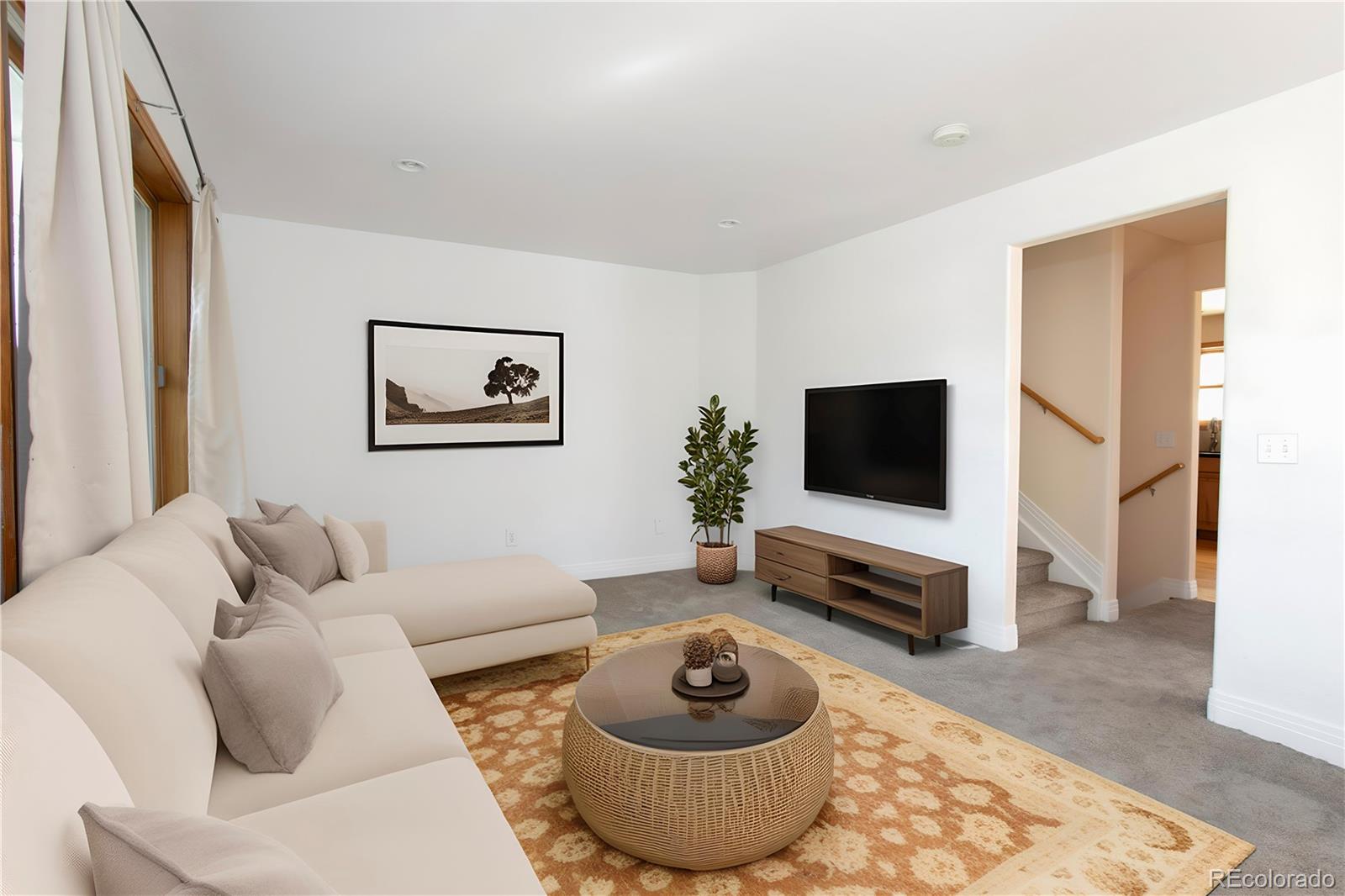 380 County Road Louisville, CO 80027 - Photo 11 of 27 a living room with furniture and a flat screen tv