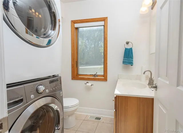 a kitchen with stainless steel appliances granite countertop a refrigerator stove top oven and sink