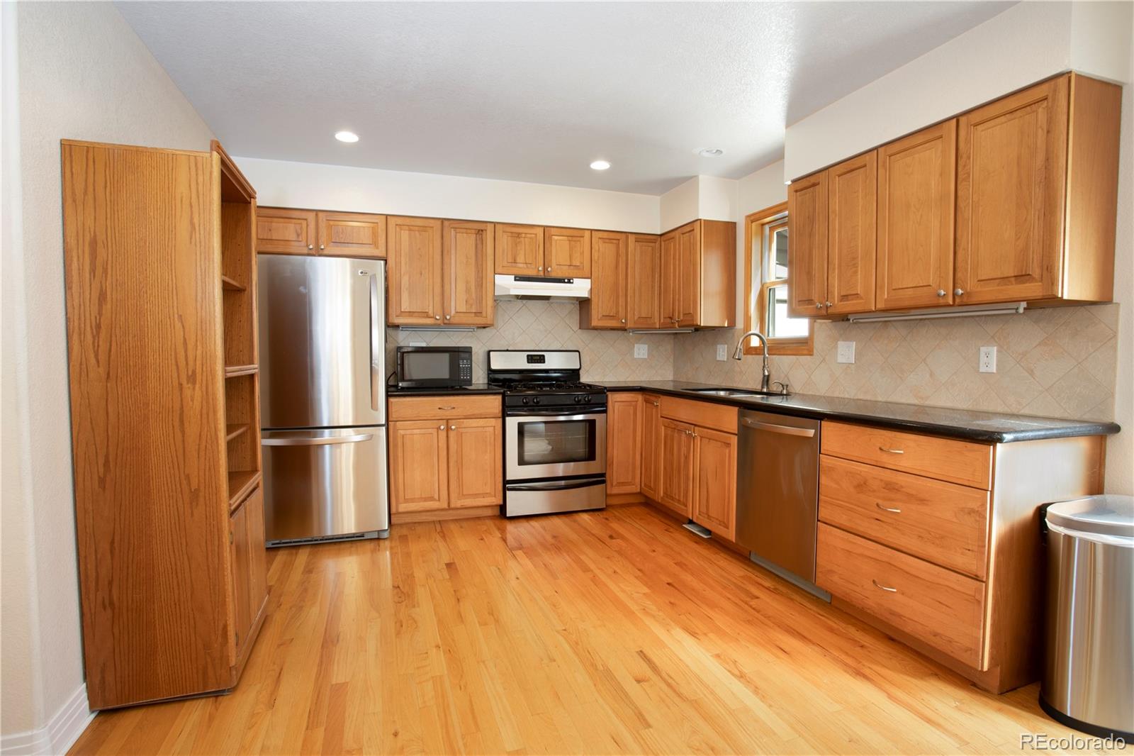 380 County Road Louisville, CO 80027 - Photo 13 of 27 a kitchen with stainless steel appliances granite countertop a refrigerator stove top oven and sink