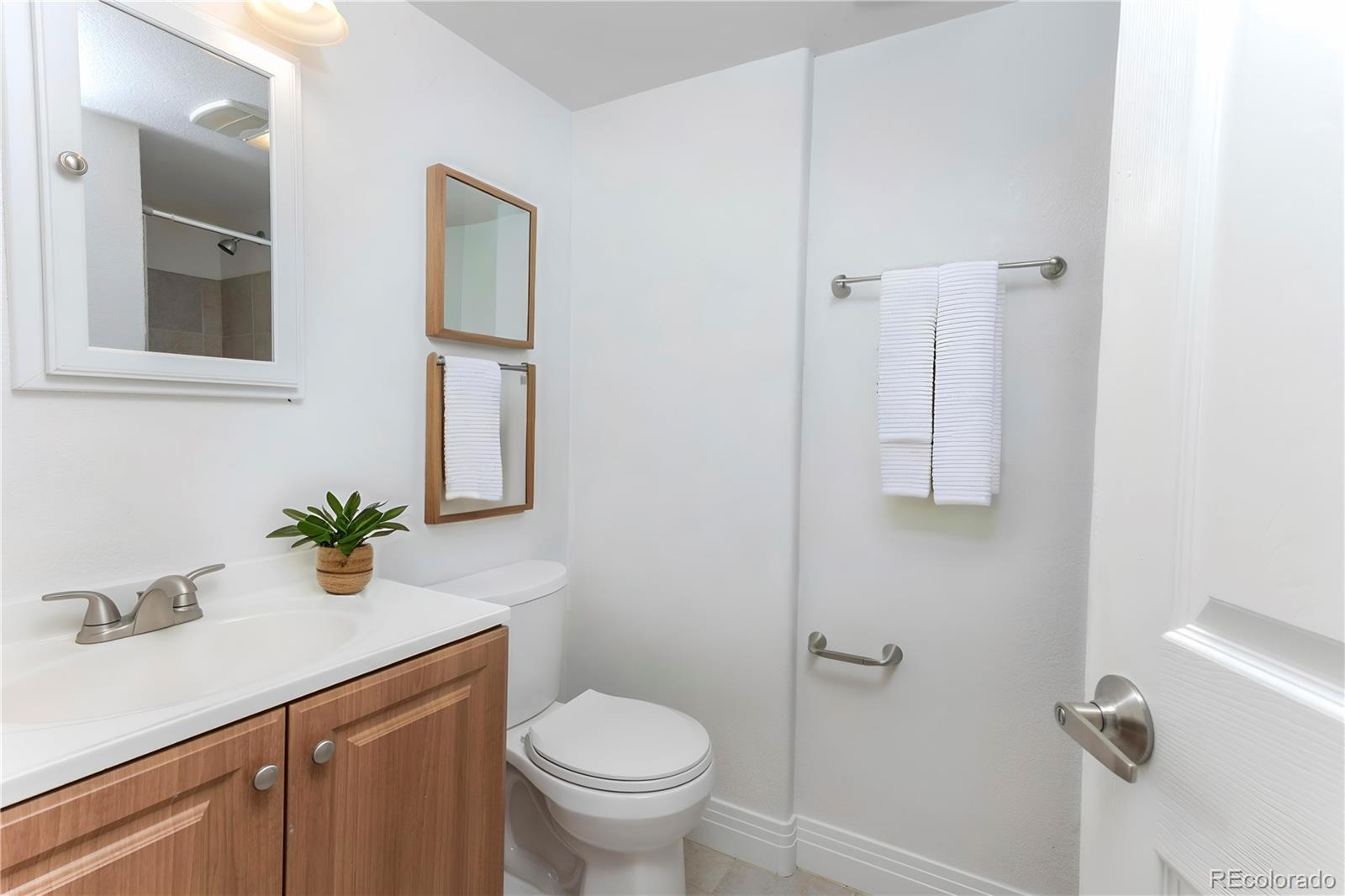 380 County Road Louisville, CO 80027 - Photo 17 of 27 a bathroom with a sink toilet and mirror