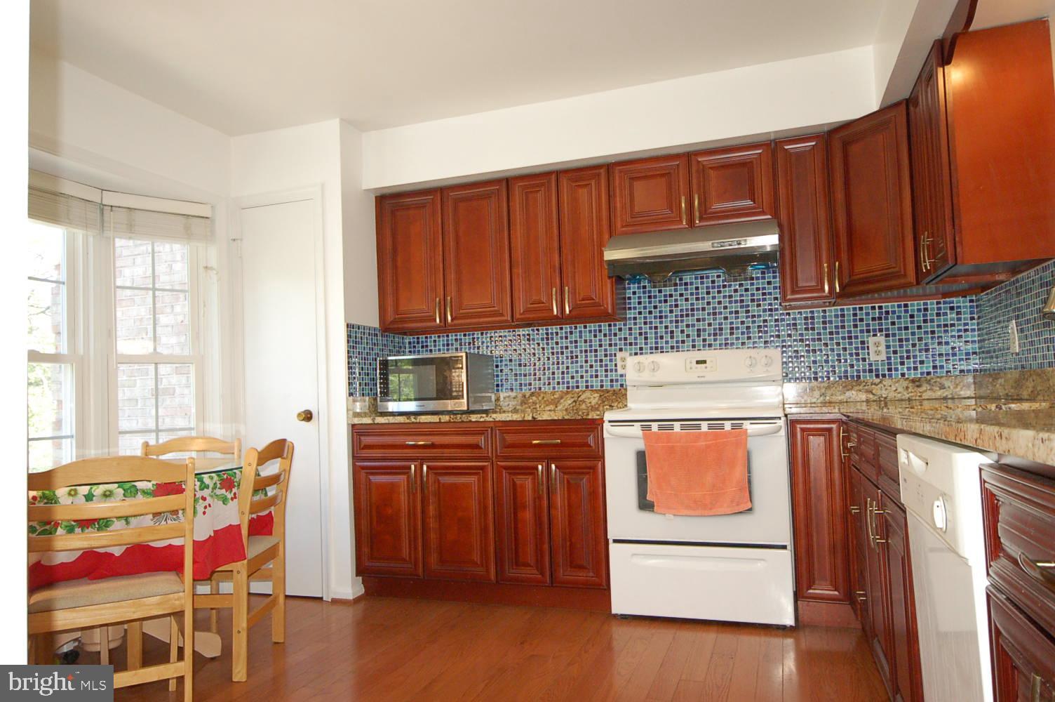 Renovated kitchen gleaming hardwood floor