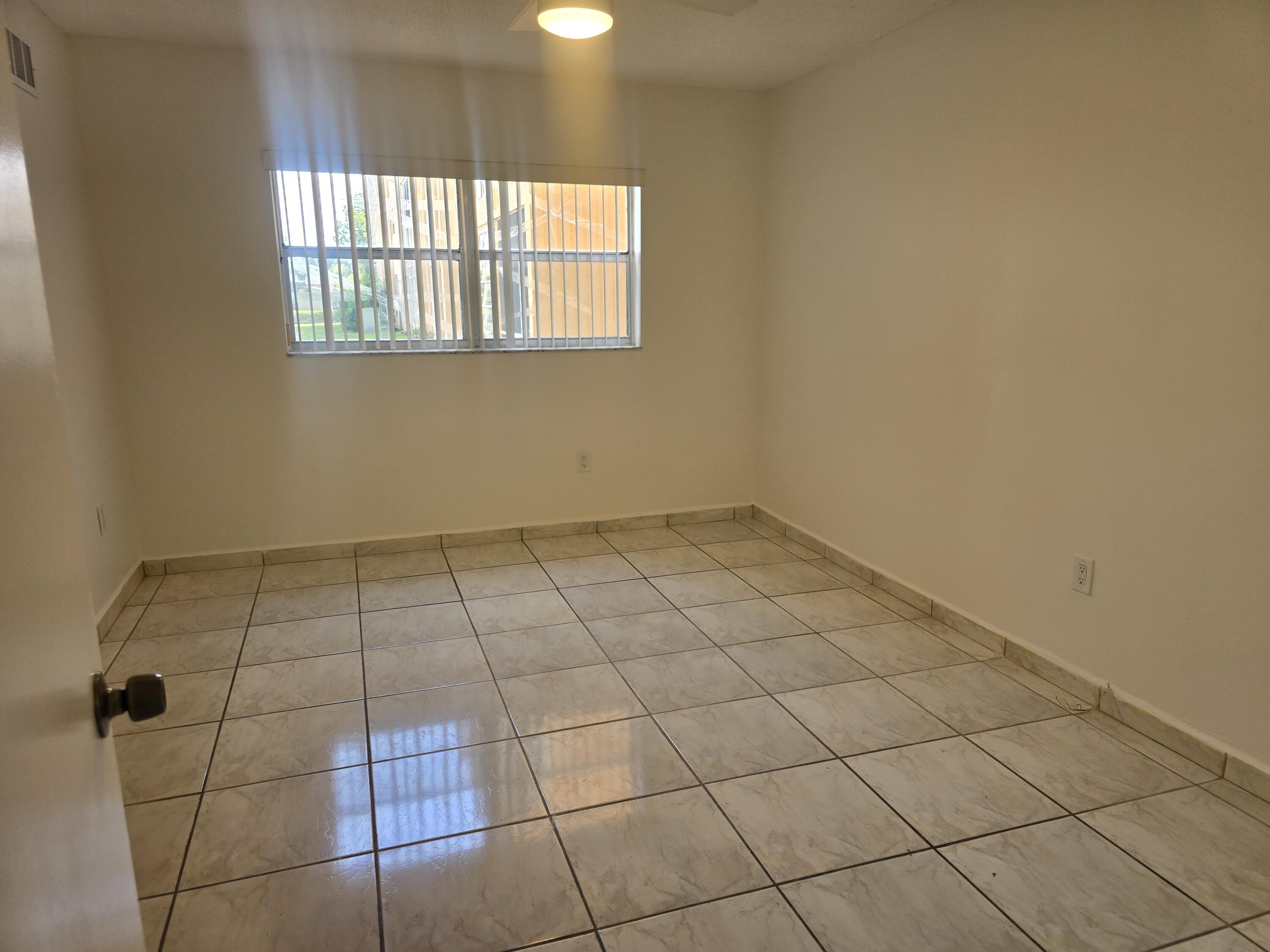 2741 North Pine Island Road, Unit 106 Sunrise, FL 33322 - Photo 11 of 14 a view of an empty room and window