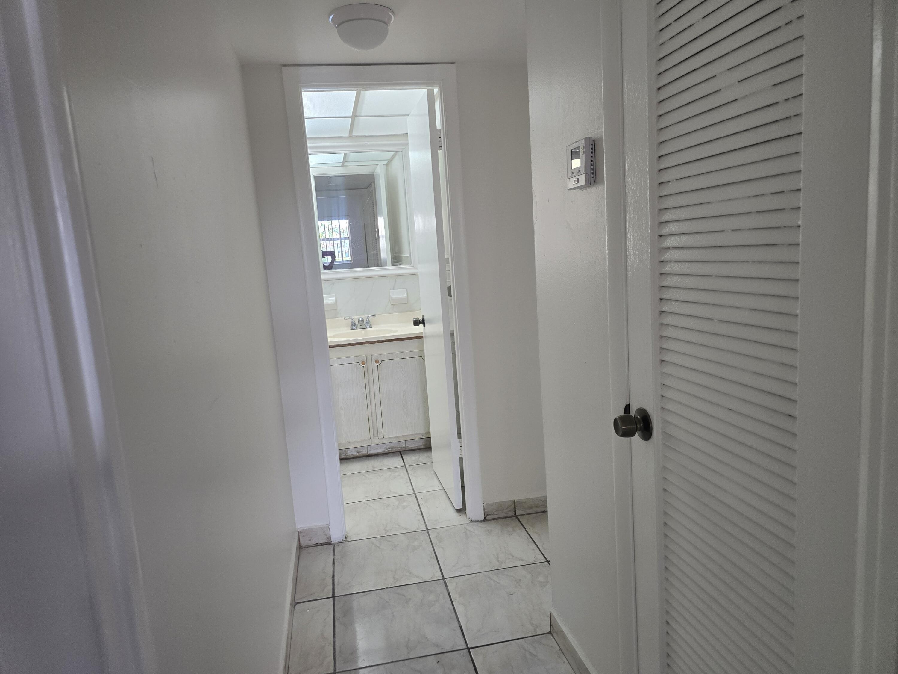 2741 North Pine Island Road, Unit 106 Sunrise, FL 33322 - Photo 14 of 14 a bathroom with a sink and a mirror