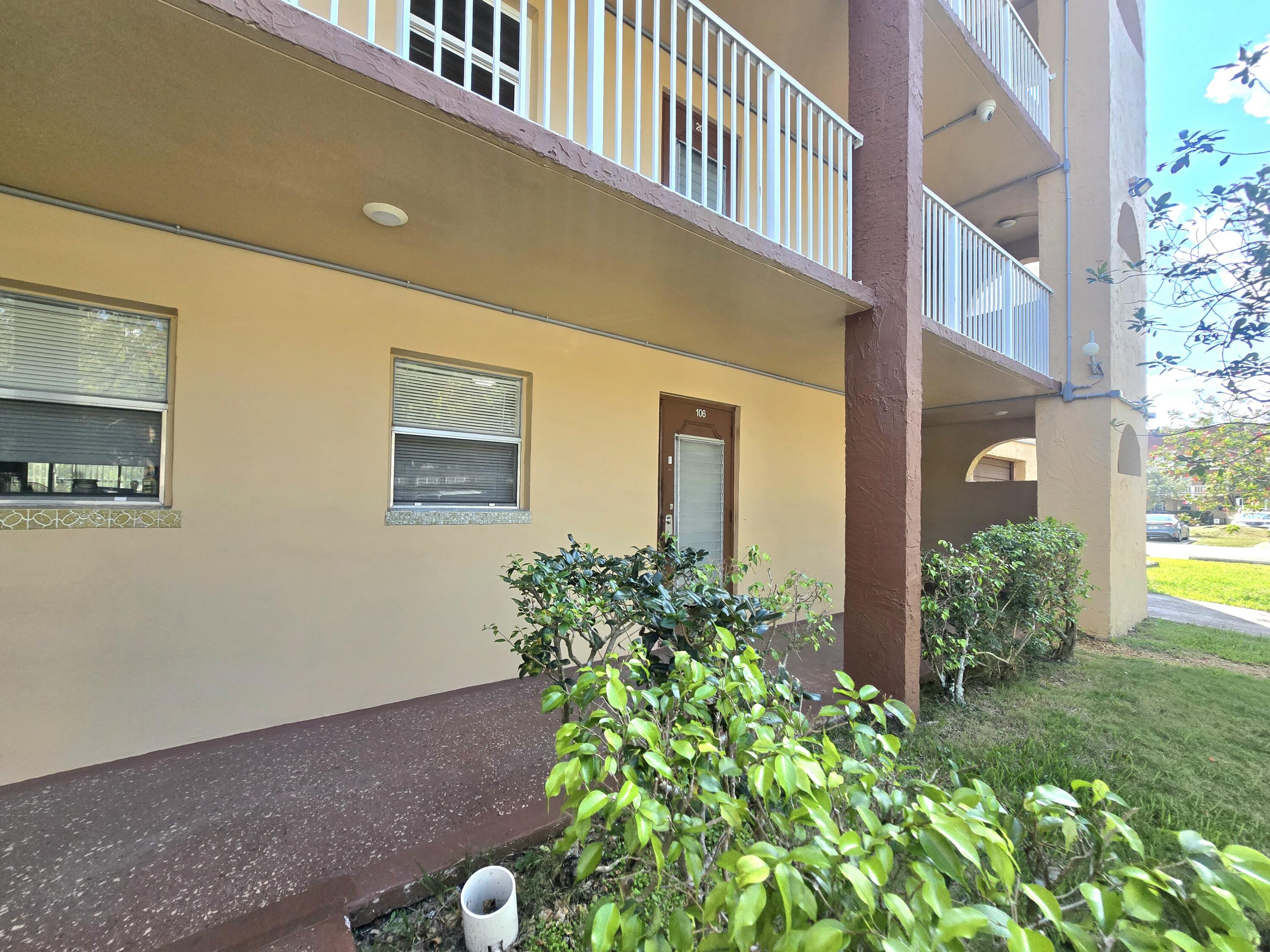 2741 North Pine Island Road, Unit 106 Sunrise, FL 33322 - Photo 2 of 14 a view of a house with potted plants