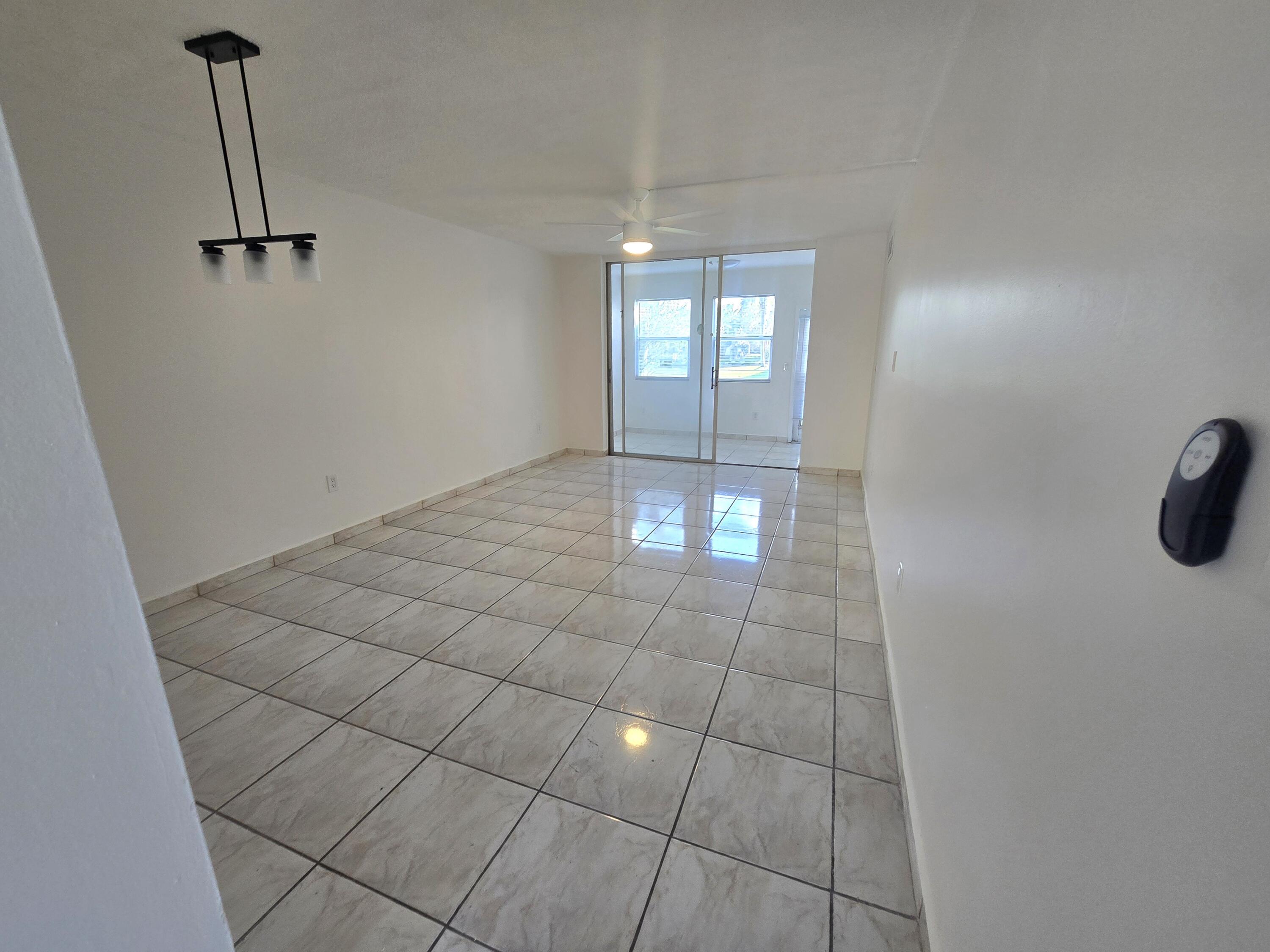 2741 North Pine Island Road, Unit 106 Sunrise, FL 33322 - Photo 4 of 14 a view of empty room with windows
