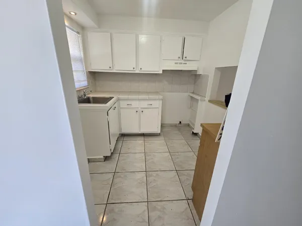 a kitchen with a sink a stove and a refrigerator