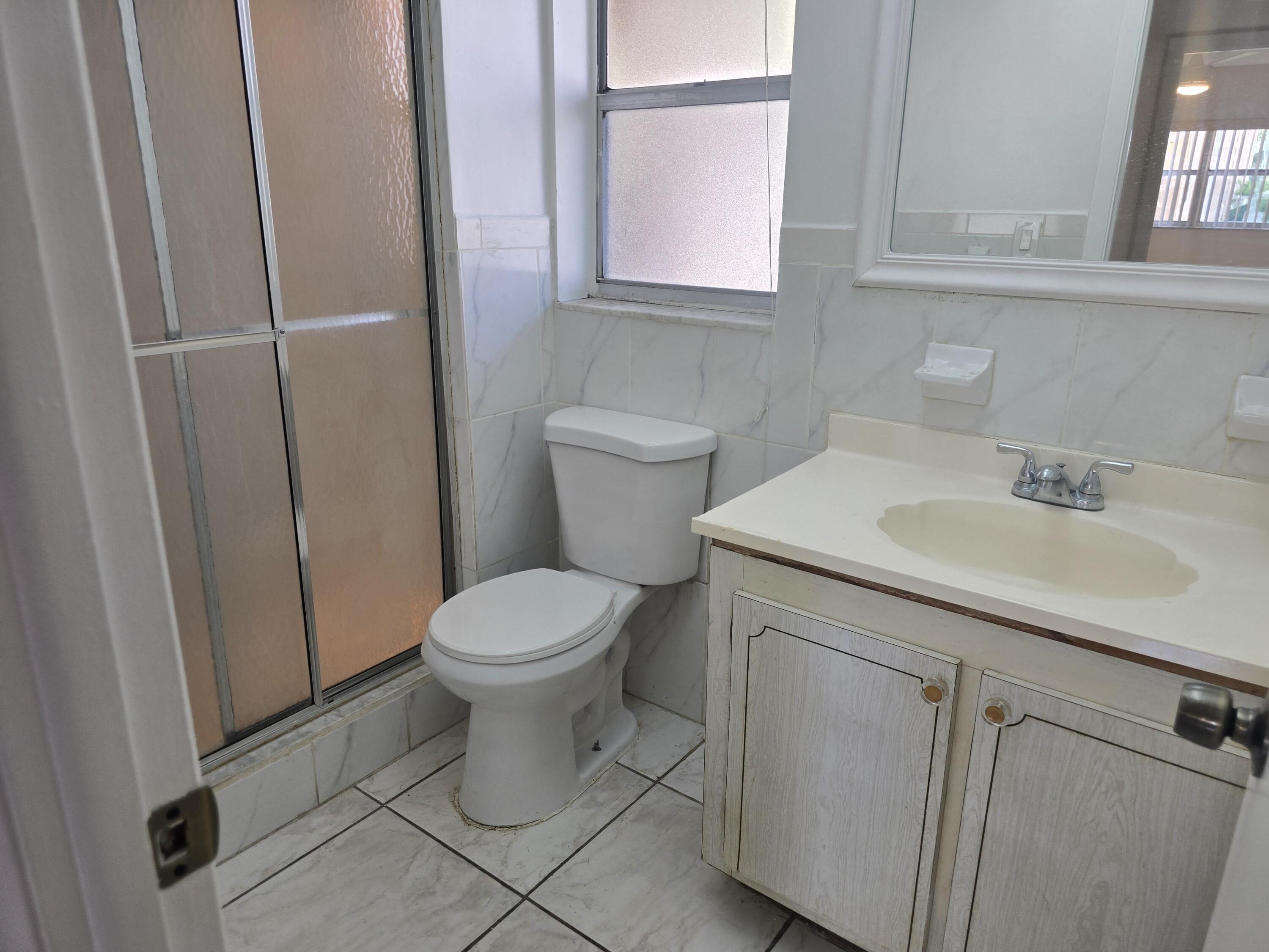 2741 North Pine Island Road, Unit 106 Sunrise, FL 33322 - Photo 10 of 14 a bathroom with a sink toilet and vanity