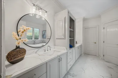a bathroom with a double vanity sink mirror and bathtub