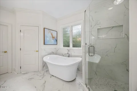 a bathroom with a bathtub and shower