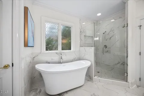 a kitchen with stainless steel appliances kitchen island wooden floors and white cabinets