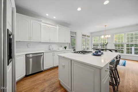 a kitchen with cabinets appliances and a counter space
