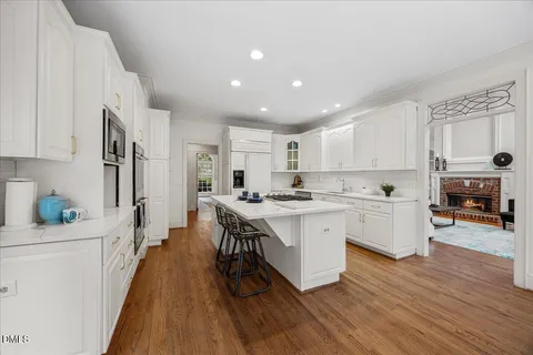 a kitchen with stainless steel appliances granite countertop a lot of counter space and wooden floors