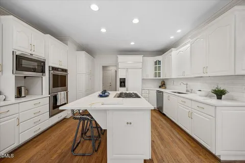 a living room with furniture a fireplace and a large window