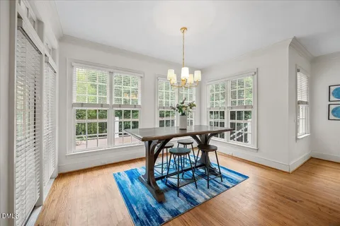 a living room with furniture fireplace and a large window