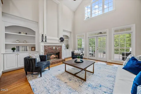 an empty room with windows and ceiling fan