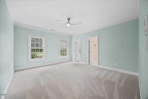 a view of an empty room with a fireplace and a window