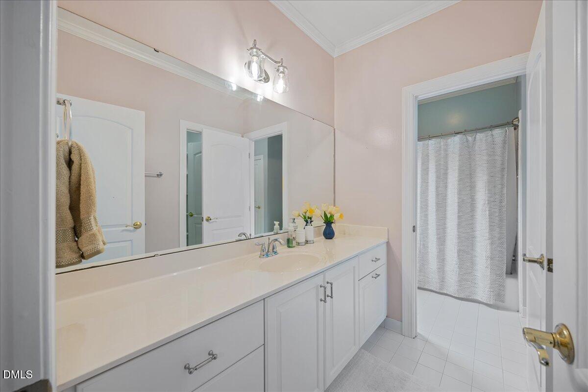 1009 Bentham Drive Raleigh, NC 27614 - Photo 39 of 69 a bathroom with a double vanity sink and a mirror