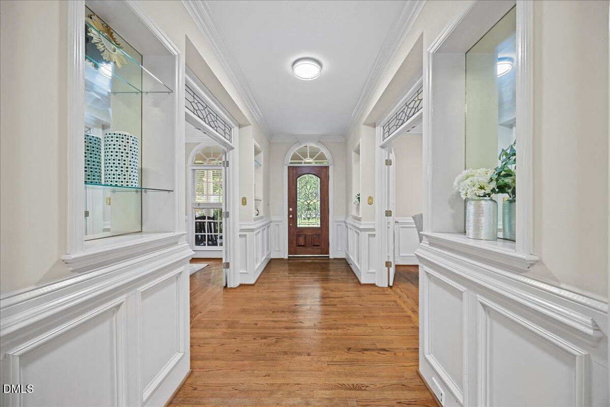 1009 Bentham Drive Raleigh, NC 27614 - Photo 4 of 69 a view of a hallway with wooden floor and staircase