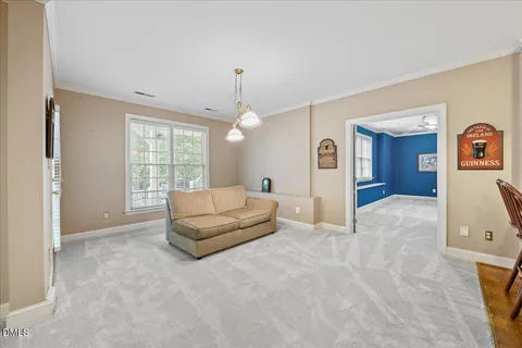a view of a patio with couches table and chairs under an umbrella with wooden floor