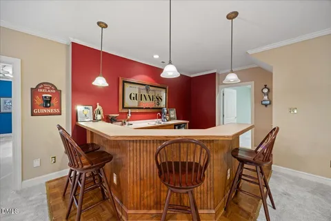 an aerial view of a house with garden space and trees all around