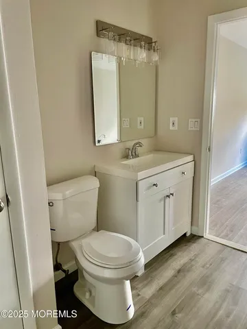 a bathroom with a sink a toilet and a mirror