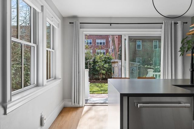 a view of a brick house with a large window and wooden floor