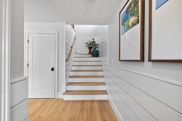 a view of a hallway with wooden floor and entryway