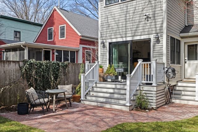a view of a house with a yard and sitting area