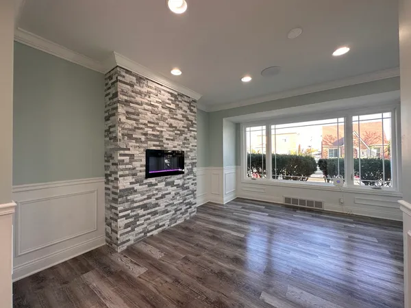 wooden floor in an empty room with a fireplace