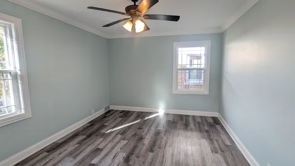 wooden floor in an empty room with a window