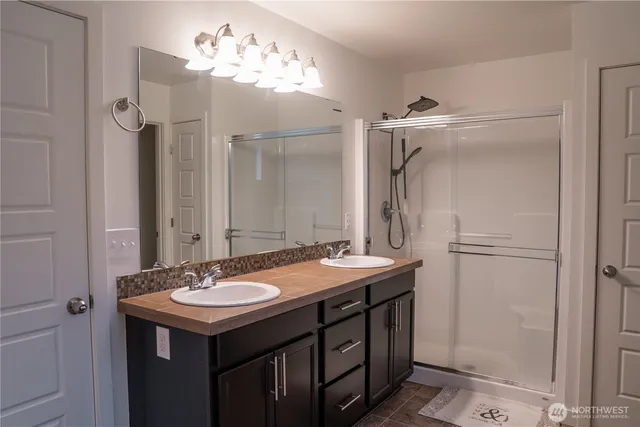a bathroom with a sink vanity and a mirror