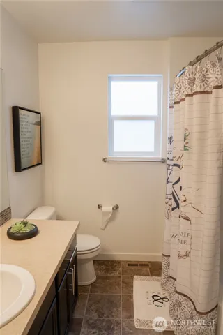 a bathroom with a sink toilet and a mirror