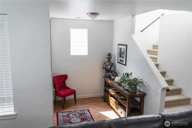 a living room with furniture and flowers