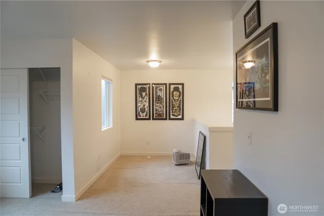 a view of a workspace with furniture and a window