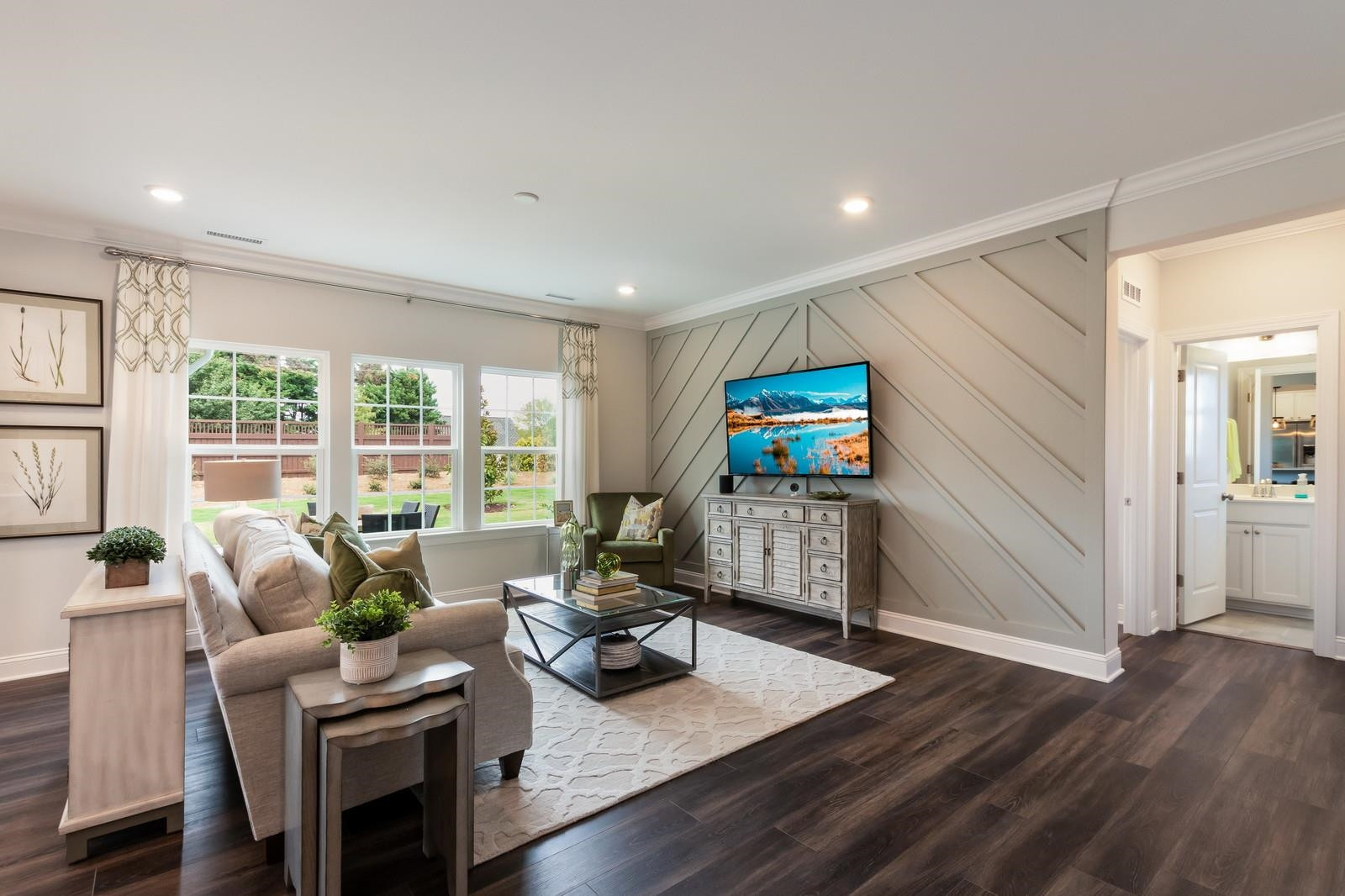 4121 Snowy Range Circle, Unit LANDRUM Raleigh, NC 27616 - Photo 14 of 27 a living room with furniture and a flat screen tv with wooden floor