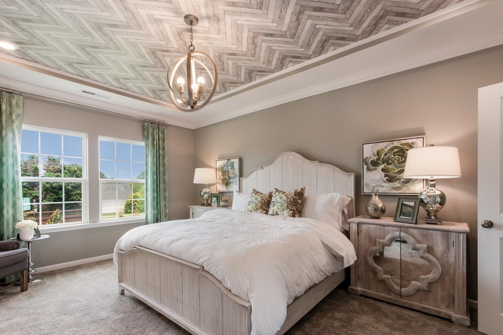 4121 Snowy Range Circle, Unit LANDRUM Raleigh, NC 27616 - Photo 19 of 27 a bedroom with a bed a chandelier and dresser