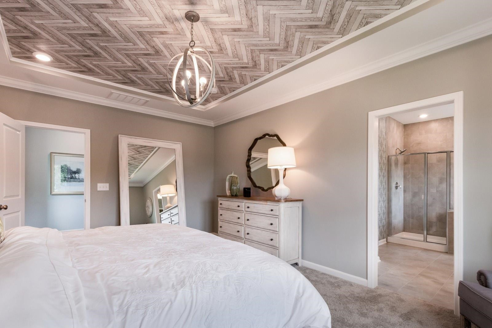 4121 Snowy Range Circle, Unit LANDRUM Raleigh, NC 27616 - Photo 20 of 27 a bedroom with a bed a chandelier and a mirror